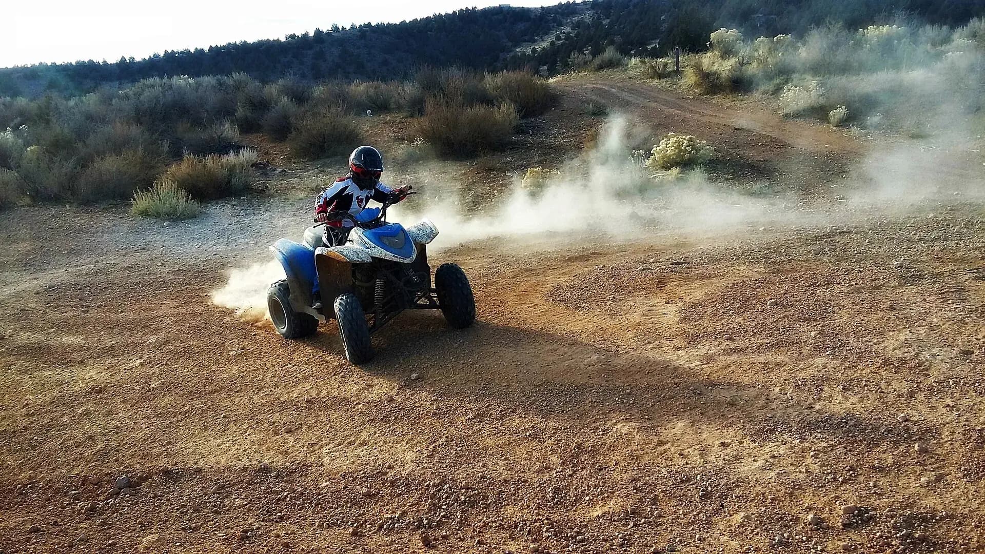 ATV kicking up dust on private ranch land in the US